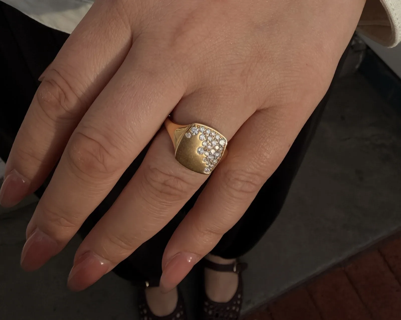 18k yellow gold cascading diamond square ring worn on the hand with an ivory sleeve