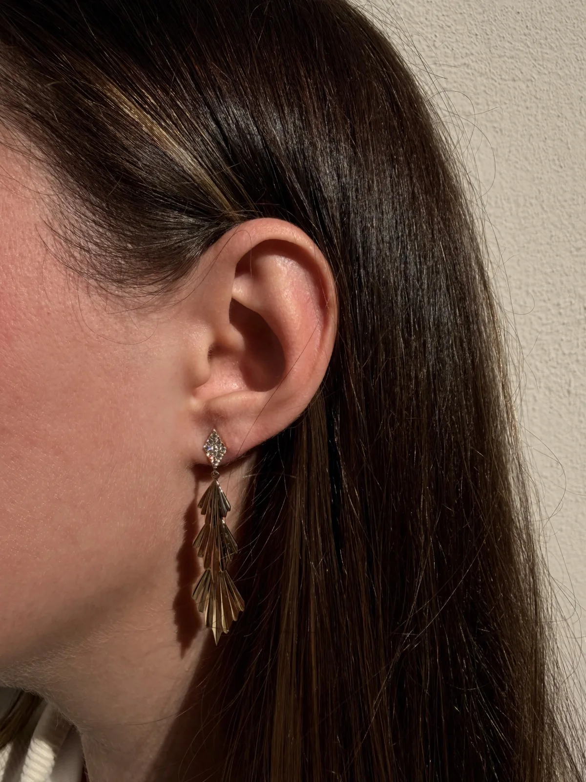 14k yellow gold fluted diamond drop earring worn on the ear